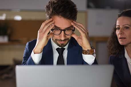 front-view-tired-man-eyeglasses-looking-laptop_458x305