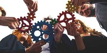 teamwork-of-businesspeople-work-together-and-combine-pieces-of-gears_360x180